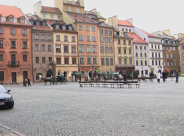 016.JPG - Another view of the old town and its main square.  Note the mixture of very modern with the car and the past with the horse and buggy.  See the cobblestone plaza which must have taken many man hours to produce.