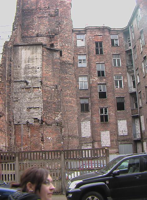 036.JPG - You are looking at the remains of part of the ghetto which has been left standing as a memorial.  You can still see some of the smoke damage imposed by the Nazis. There are people living in this building.